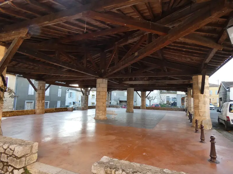Charpente en bois d’une halle de marché, posée sur des piliers de pierre